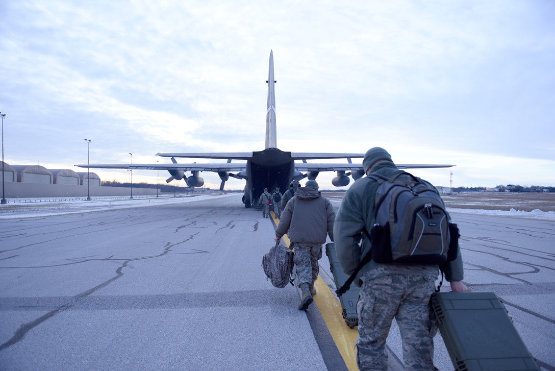 airmen walking to an aircraft