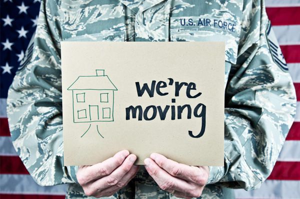Airman holding a We're Moving sign