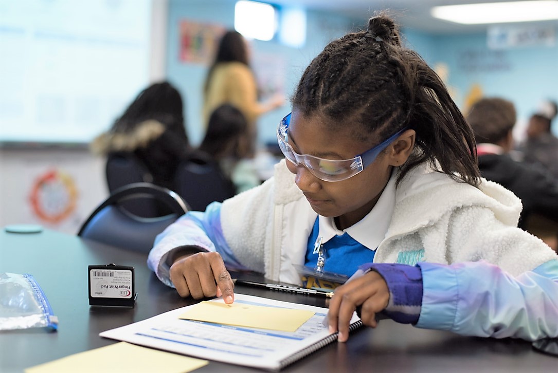 Child wearing saftey glasses in a classroom