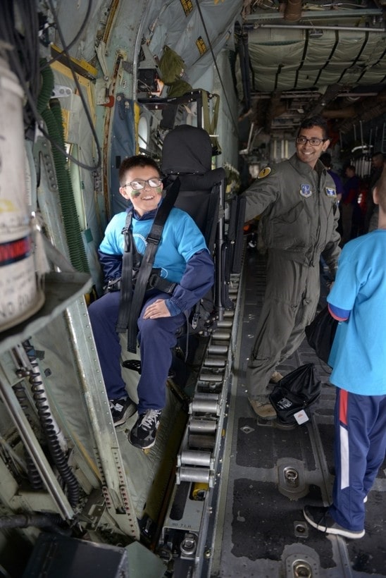 young boy sitting in a seat in an aircraft