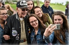 veteran having his picture made with a group of kids