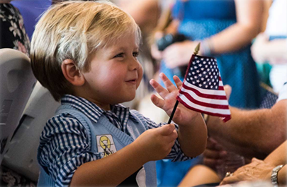 Young boy holding an american flag
