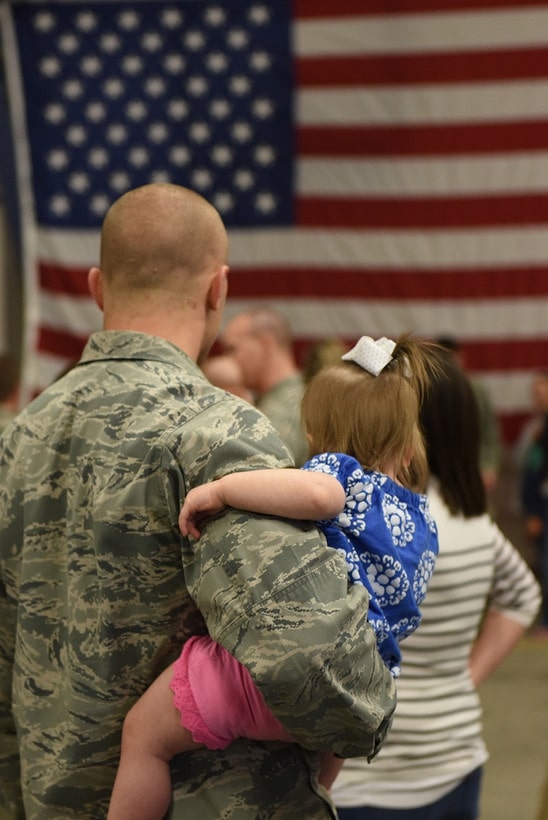 Airman holding his daughter