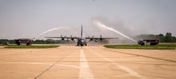 water spraying over a c130 aircraft