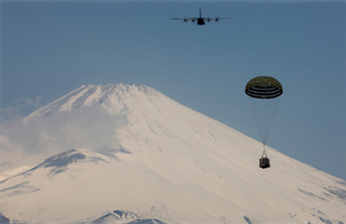 c130 making an air drop of supplies