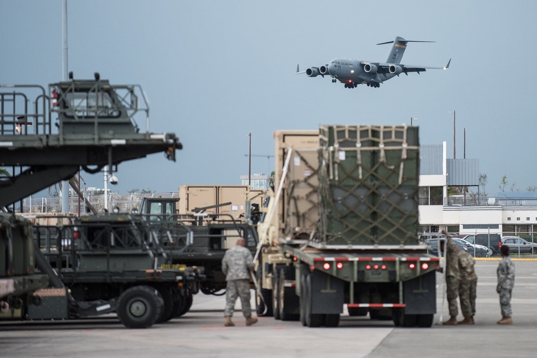 Air Force base ramp with military equipment staged