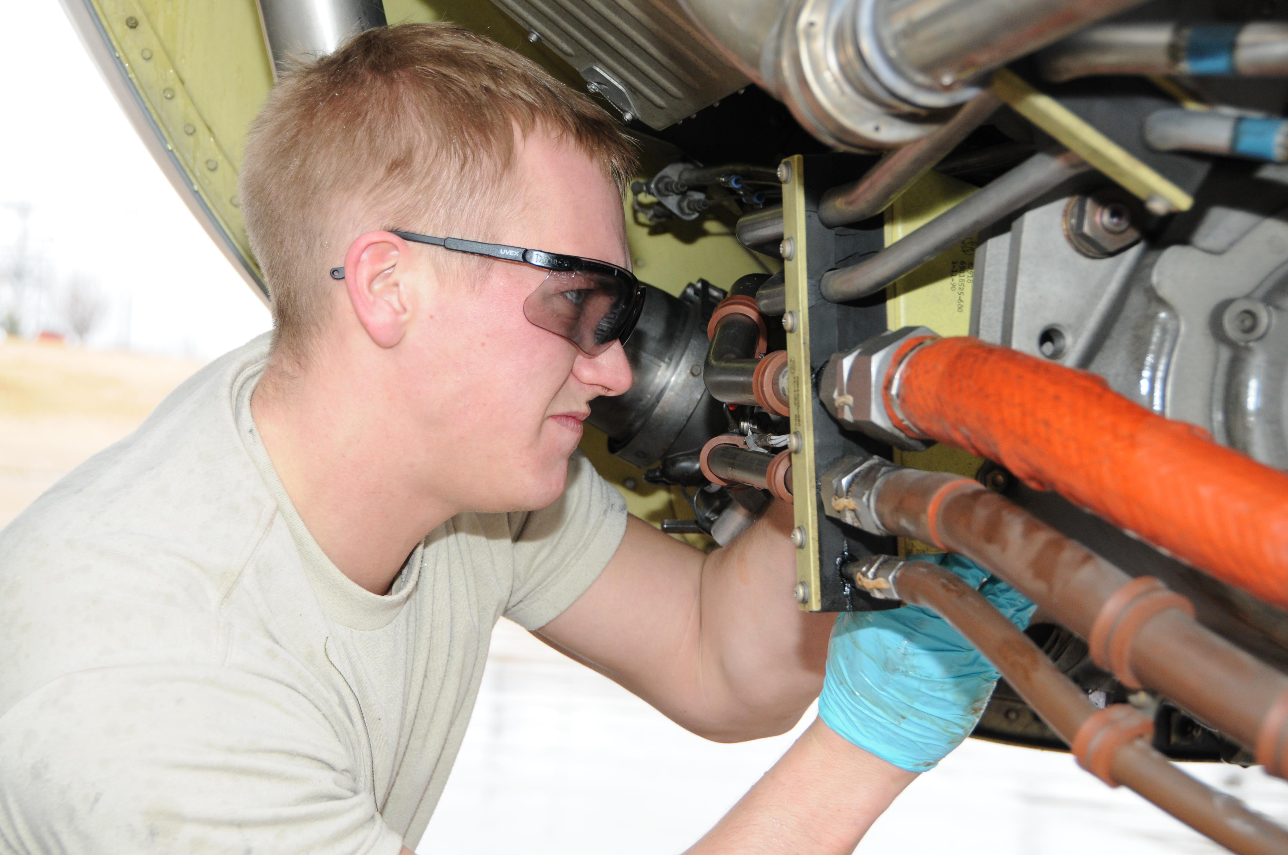 airmen working on hydraulics