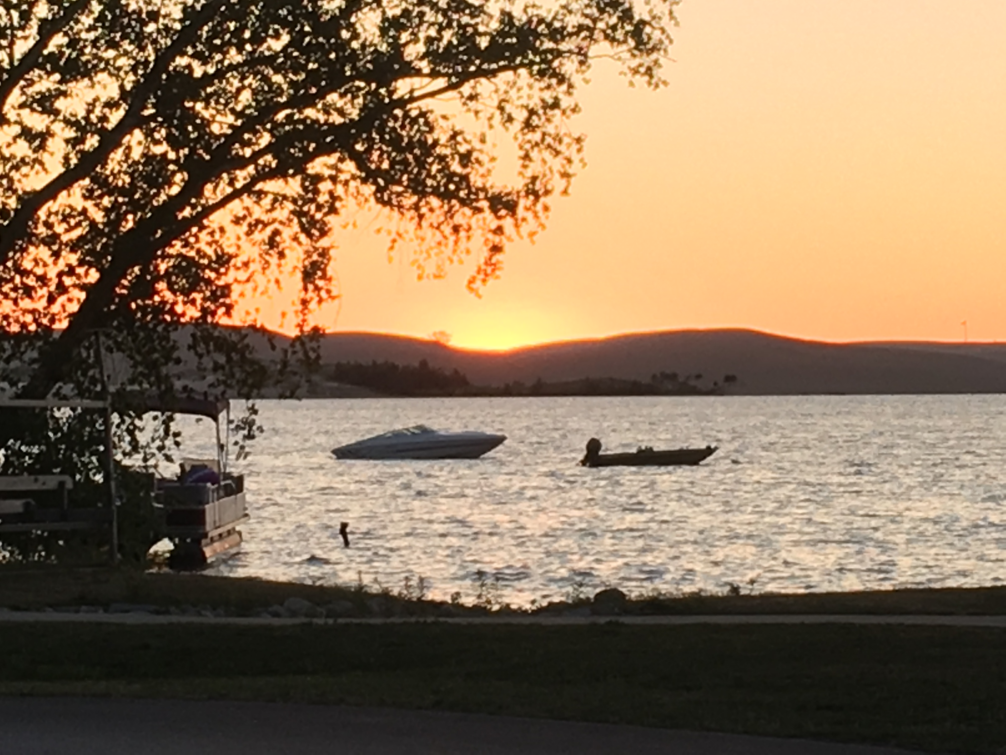 two boats on the lake at sunset