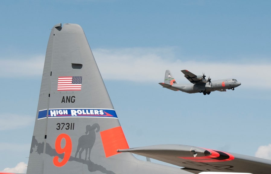 152th Air Wing C130 Tail that says High Rollars with another C130 flying in the background