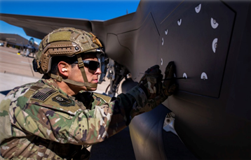 Airman taking an access panel off
