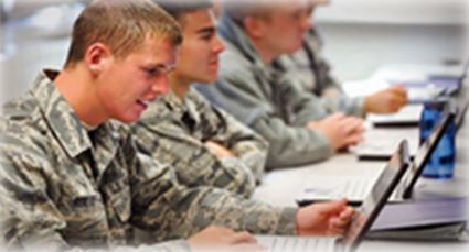 Service members working on laptops