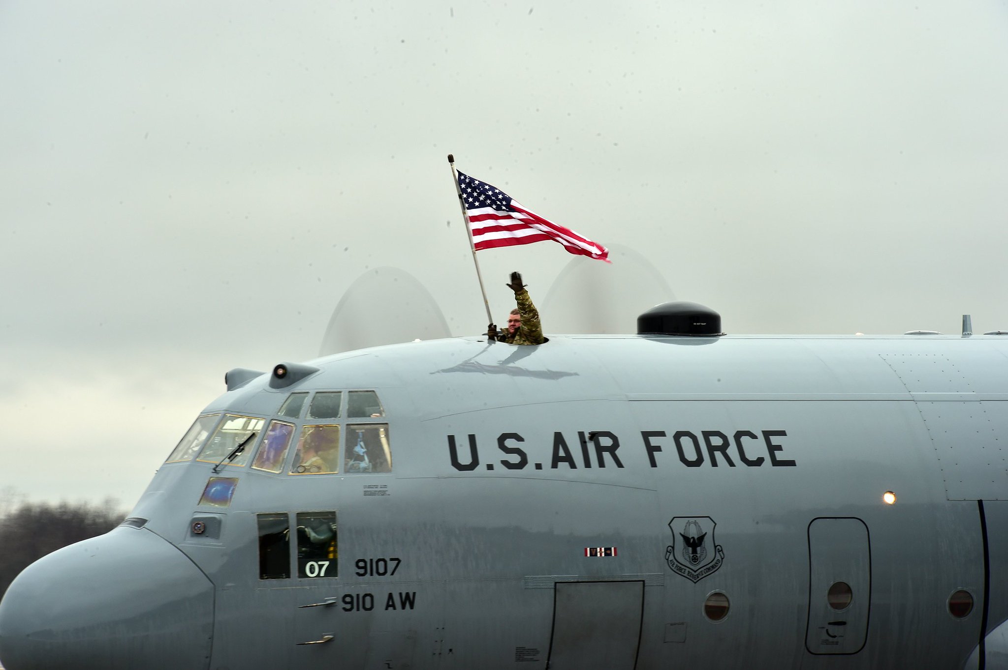 C130 with an american flag flying out the top