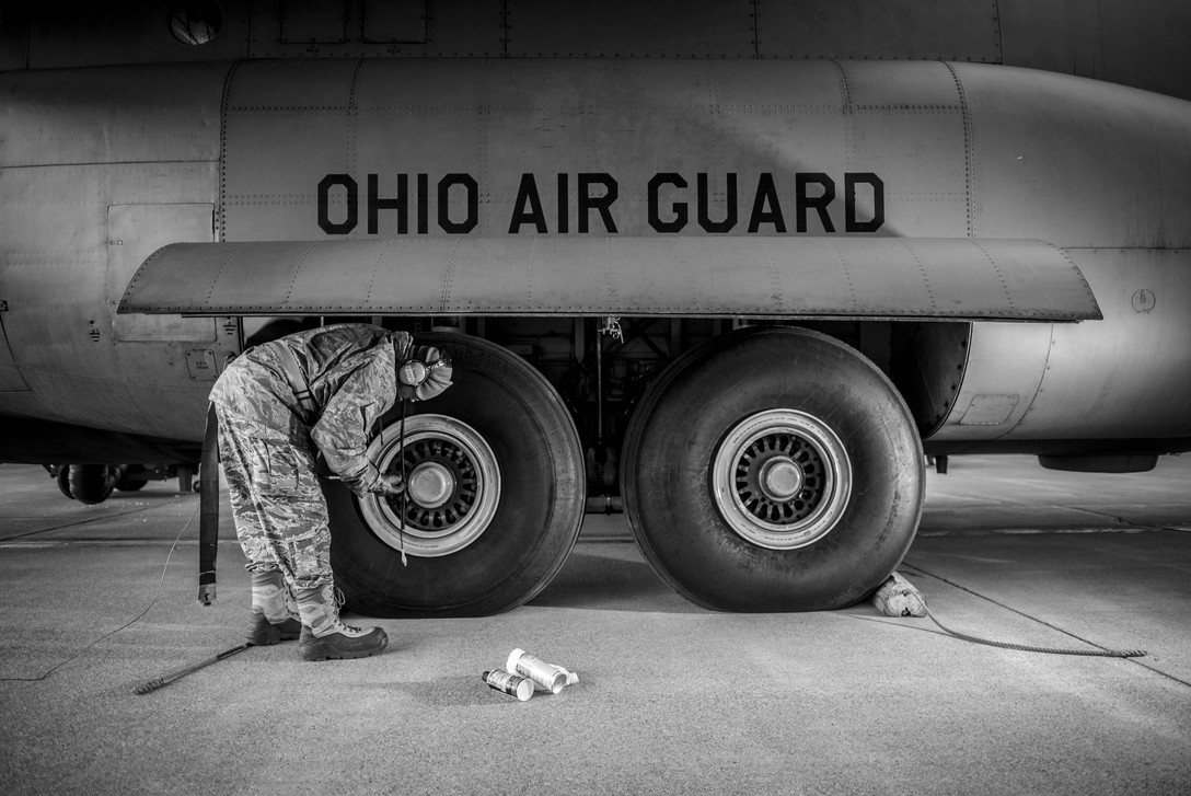 Crew checking tires on an aircraft