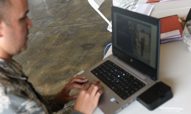 Airman working on a laptop