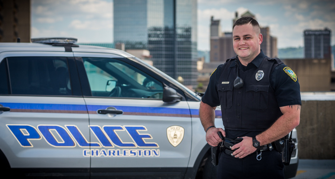 police officer standing next to his car