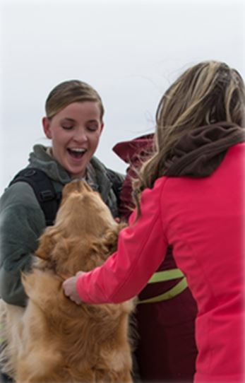 Airman being greeted by her dog